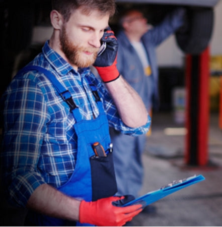 Man wearing heavy duty industrial gloves with touchscreen connectivity using GloveTacts stickers.